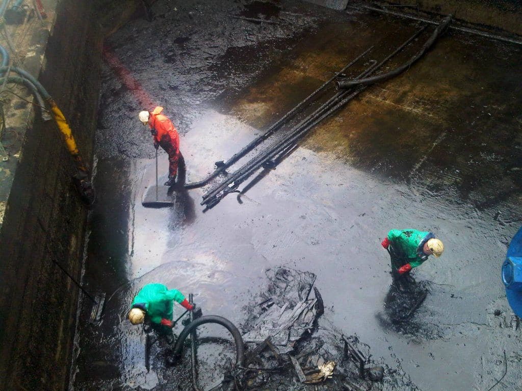 Tank bund being cleaned out by a MacWaste operative